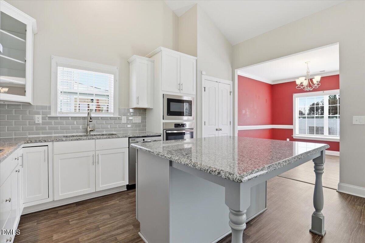 157 Ramsgate Drive Clayton, NC 27520 - Photo 10 of 42 a kitchen with stainless steel appliances granite countertop a sink stove and refrigerator