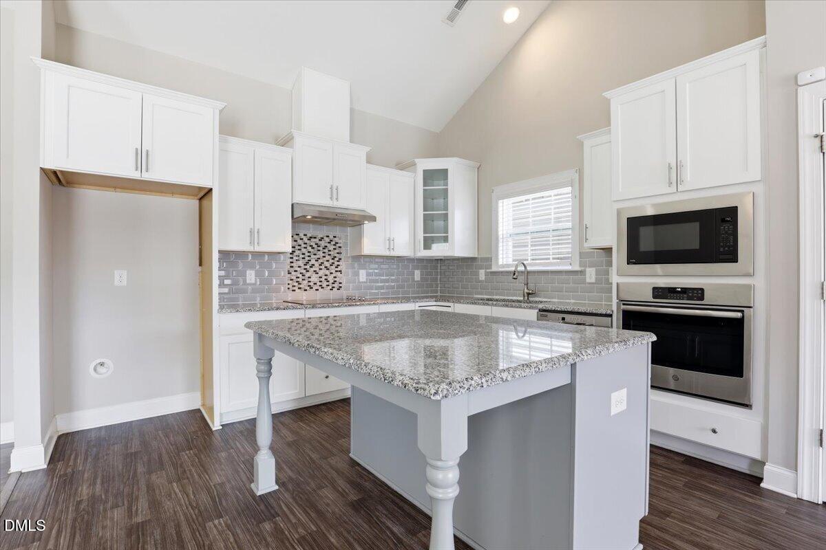 157 Ramsgate Drive Clayton, NC 27520 - Photo 15 of 42 a kitchen with stainless steel appliances granite countertop a sink stove and refrigerator