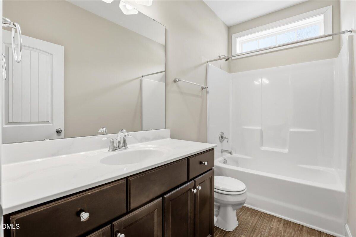 157 Ramsgate Drive Clayton, NC 27520 - Photo 26 of 42 a bathroom with a sink a toilet a mirror and shower