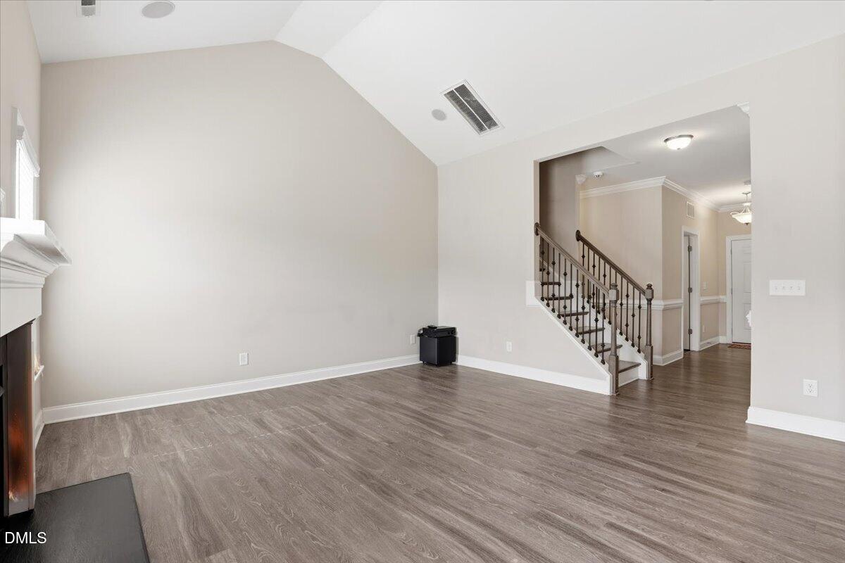 157 Ramsgate Drive Clayton, NC 27520 - Photo 32 of 42 an empty room with wooden floor and windows