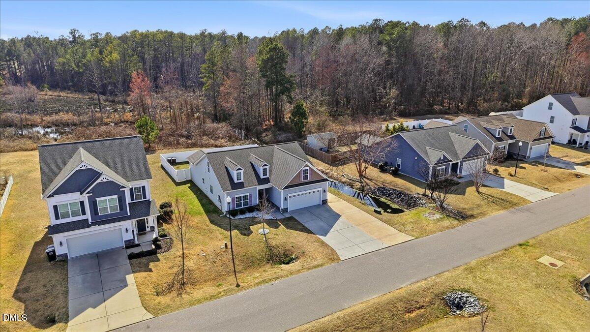 157 Ramsgate Drive Clayton, NC 27520 - Photo 39 of 42 a view of a house with pool and trees in the background