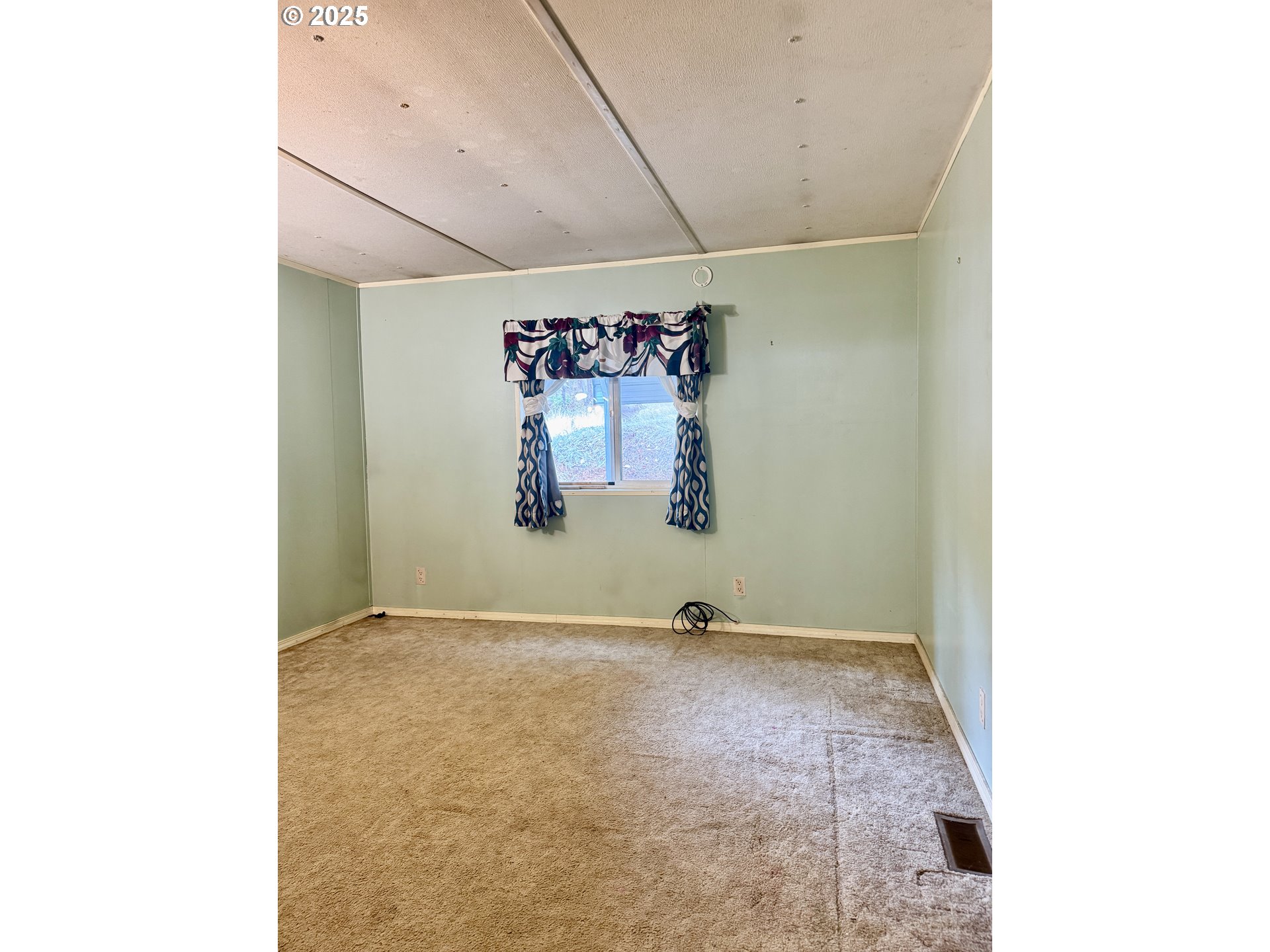 2263 Canyonville-Riddle Road Riddle, OR 97469 - Photo 9 of 36 a view of a room with window and picture on the wall