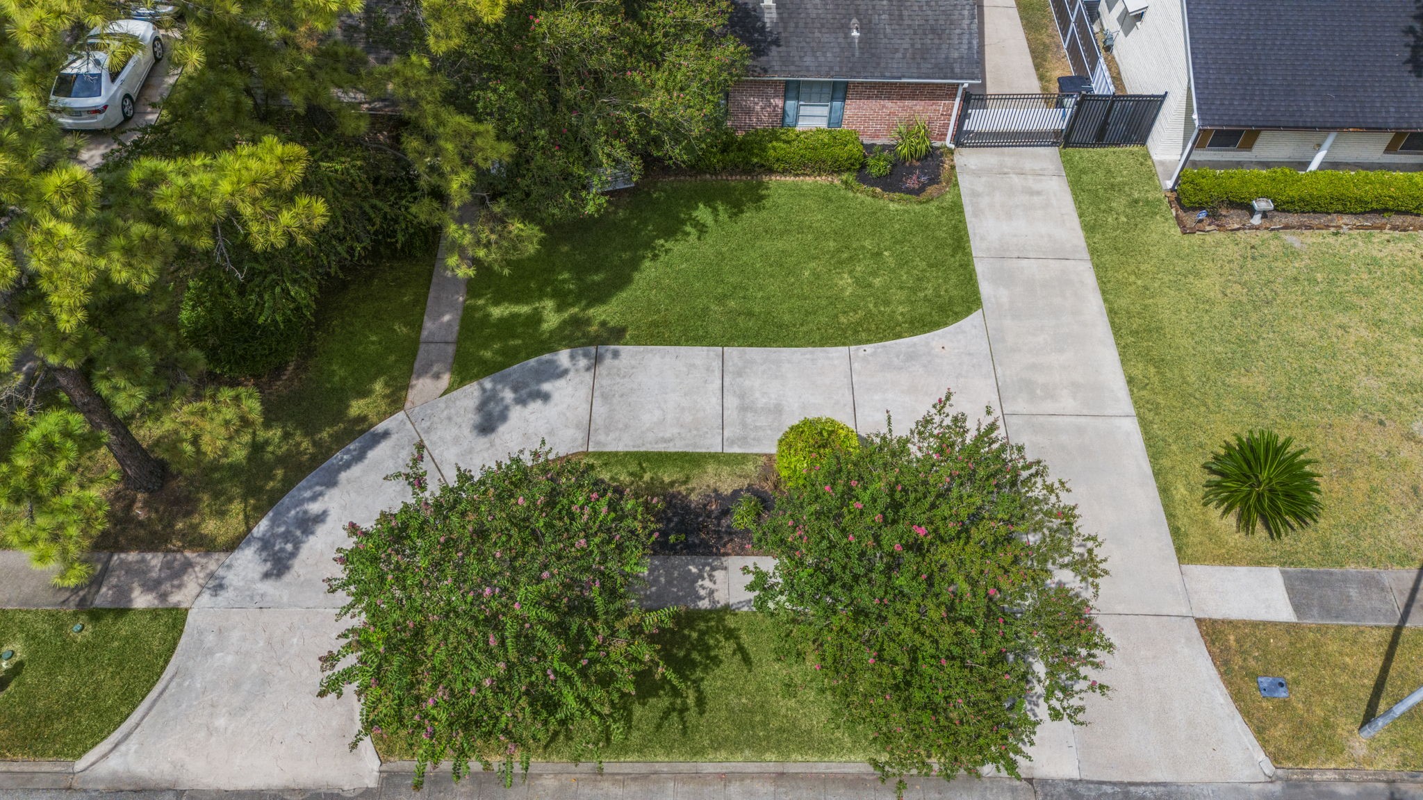 6102 Redding Road Houston, TX 77036 - Photo 2 of 40 The home is set back from the road and features a gated driveway, offering added privacy and security.