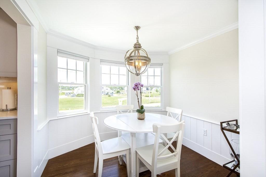 43 Surfside Road Scituate, MA 02066 - Photo 11 of 40 a dining room with furniture a chandelier and wooden floor