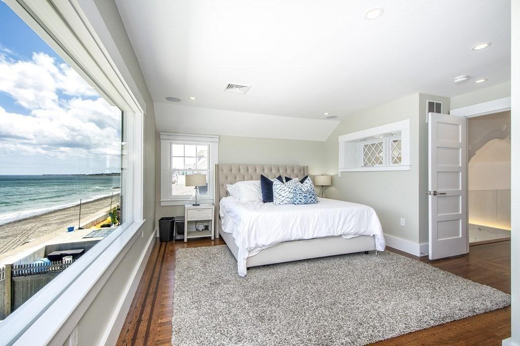 43 Surfside Road Scituate, MA 02066 - Photo 20 of 40 a spacious bedroom with a bed and large windows
