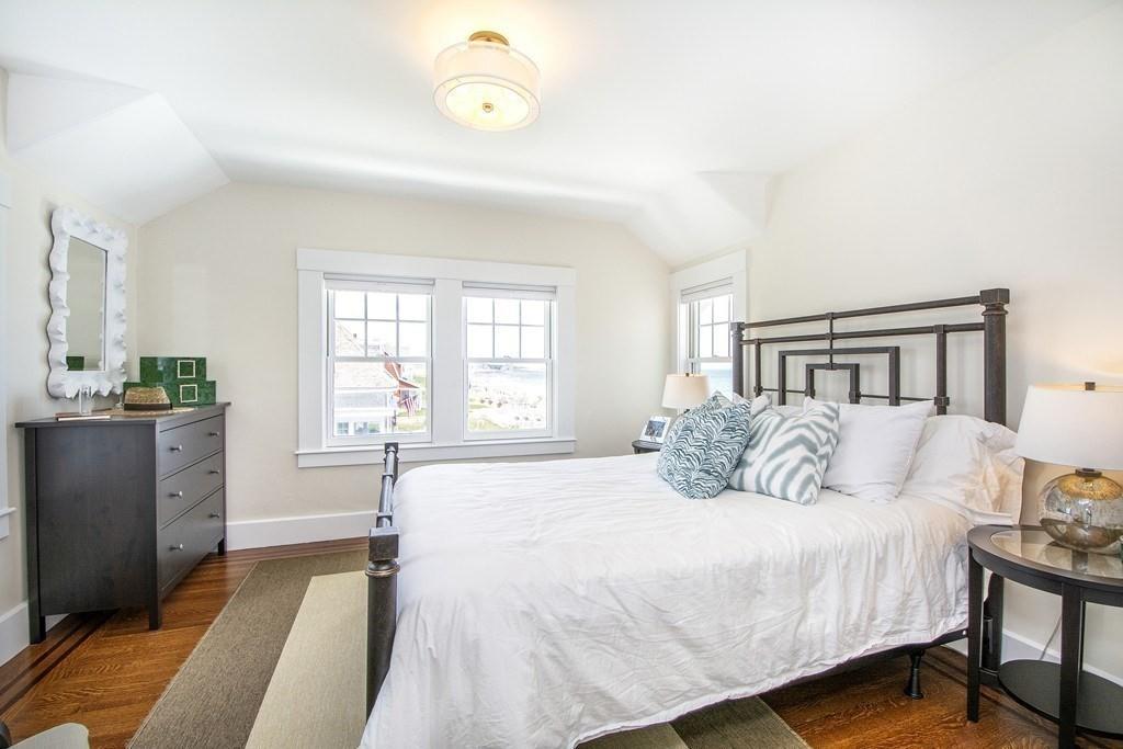 43 Surfside Road Scituate, MA 02066 - Photo 23 of 40 a bedroom with a bed and wooden floor