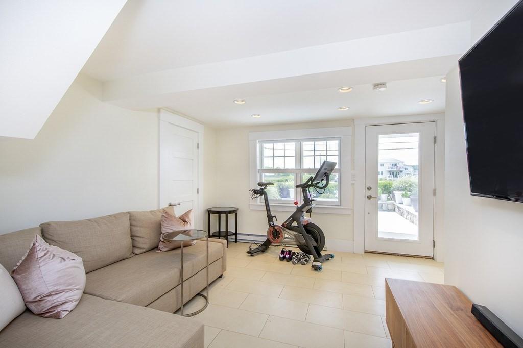 43 Surfside Road Scituate, MA 02066 - Photo 28 of 40 a living room with furniture a large window and a flat screen tv