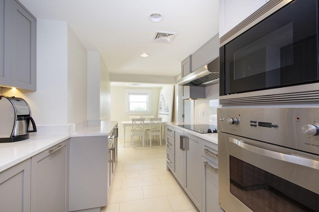 43 Surfside Road Scituate, MA 02066 - Photo 32 of 40 a kitchen with stainless steel appliances granite countertop a sink and dishwasher a stove with wooden floor