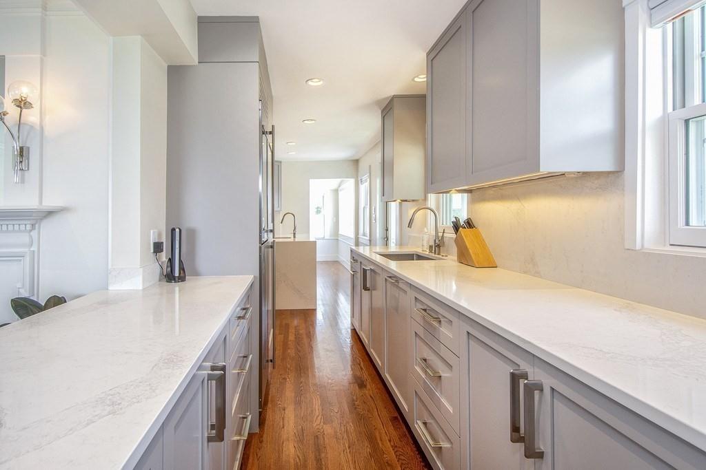 43 Surfside Road Scituate, MA 02066 - Photo 8 of 40 a kitchen with a sink a counter top space stainless steel appliances and cabinets