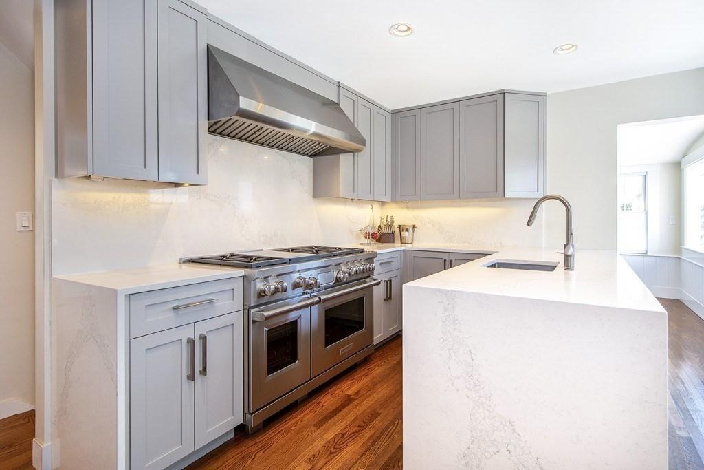 43 Surfside Road Scituate, MA 02066 - Photo 9 of 40 a kitchen with a stove top oven and cabinets