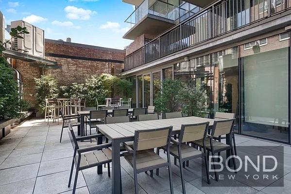 237 East 34th Street, Unit 706 Manhattan, NY 10016 - Photo 11 of 25 a view of a patio with table and chairs and potted plants