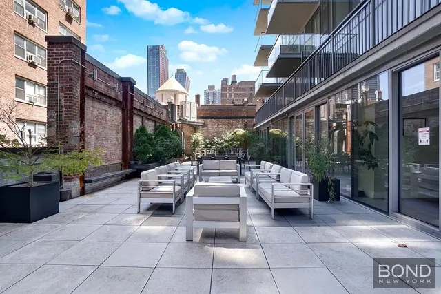 a view of a patio with couches and potted plants