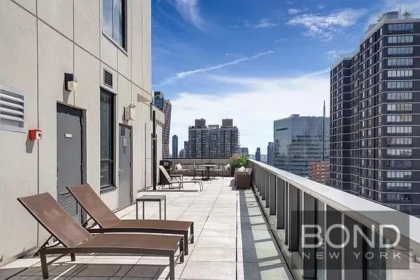 a view of balcony with outdoor seating and city view