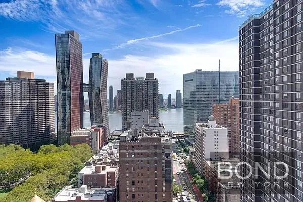 a view of a cars park in front of a building