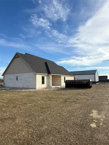 a front view of house with yard and car parked