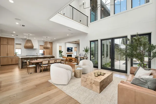 a kitchen with stainless steel appliances granite countertop a sink a stove and a wooden floors