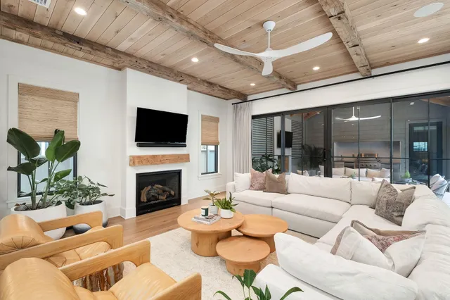 a living room with furniture a large window and a bathtub