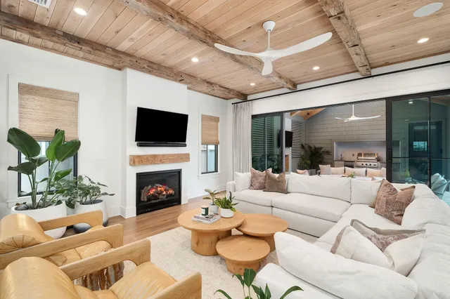 a living room with furniture a rug and wall painting