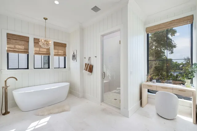 an aerial view of residential houses with outdoor space and trees