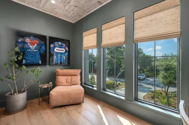 an aerial view of residential houses with outdoor space and ocean view