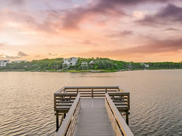 a living room with furniture kitchen view and a large window