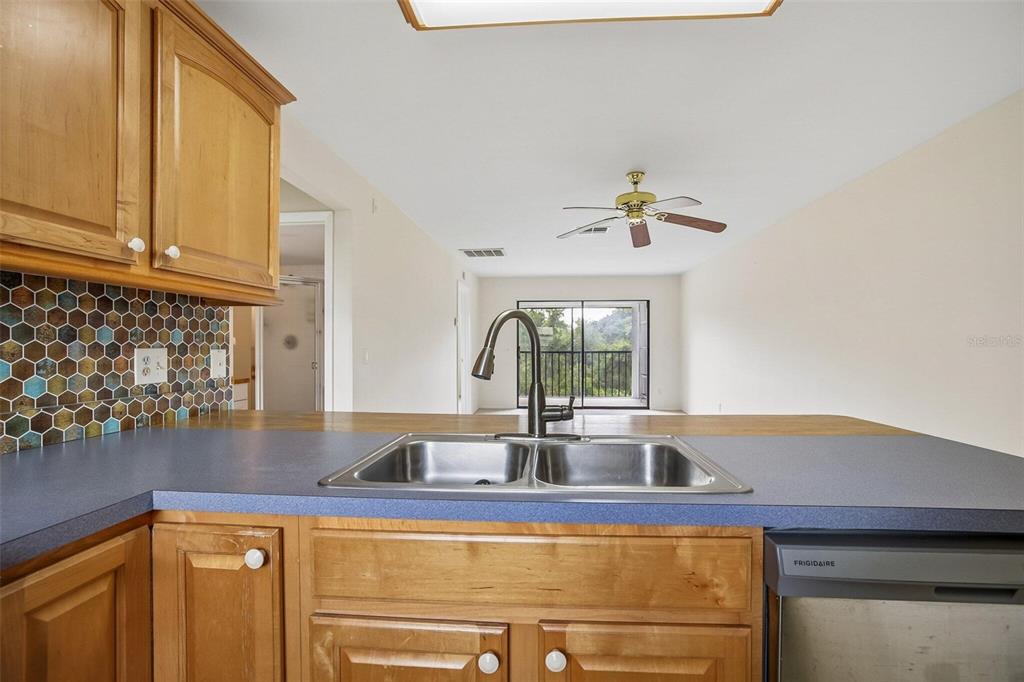 26485 Rampart Boulevard, Unit A27 Punta Gorda, FL 33983 - Photo 13 of 27 a kitchen with a sink and a window