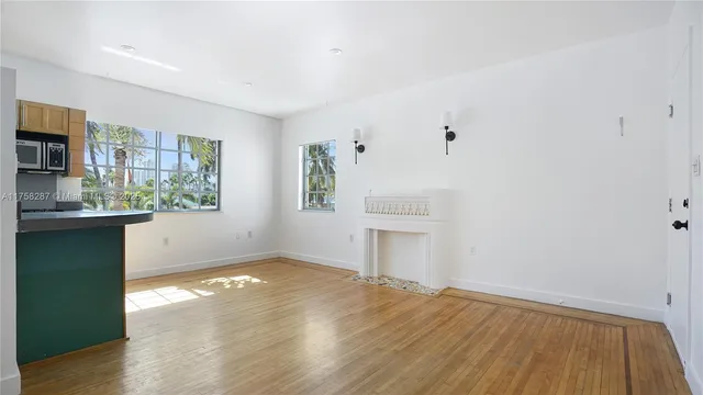 a view of a kitchen with wooden floor and a kitchen space