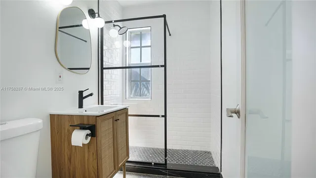 a bathroom with a sink a mirror a vanity and window