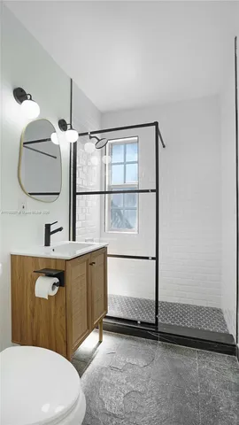 a bathroom with a sink a toilet and vanity