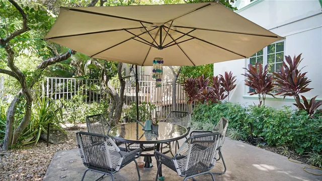 a patio with a patio table and chairs