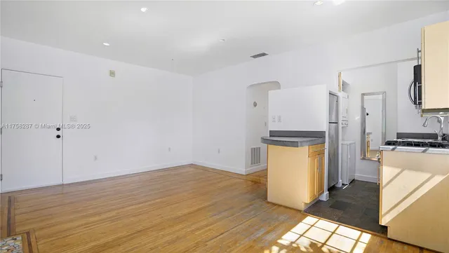 a view of a kitchen with wooden floor