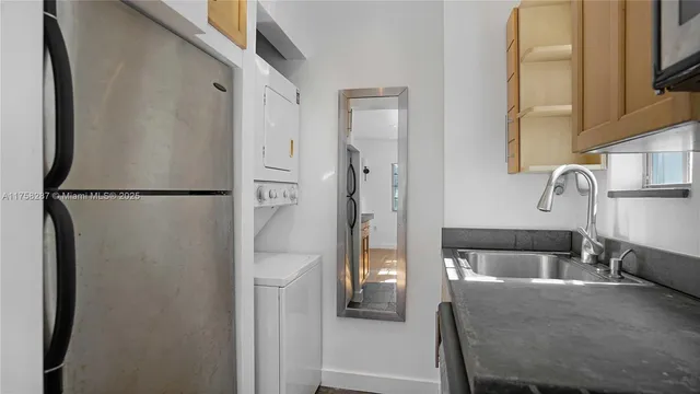 a bedroom with a bed and a refrigerator