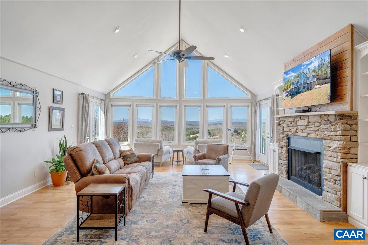 439 Gardner Farm Road Appomattox, VA 24522 - Photo 14 of 73 a living room with furniture a fireplace and a floor to ceiling window