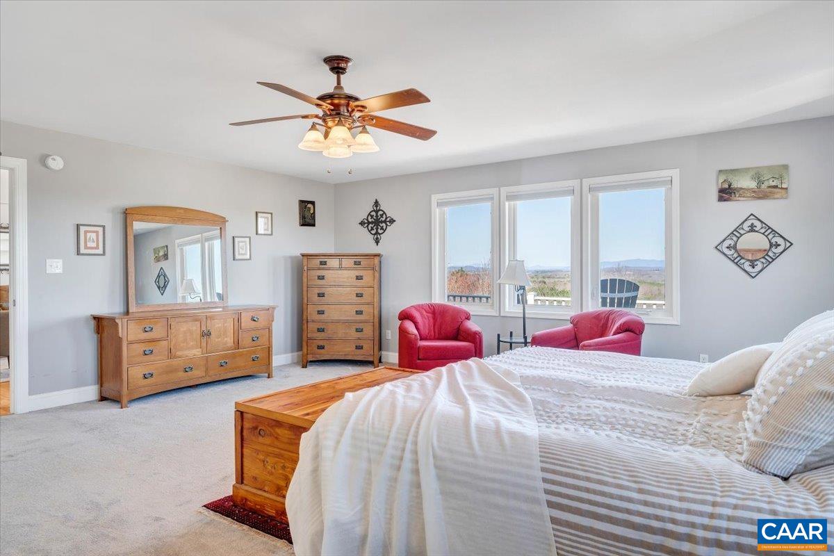 439 Gardner Farm Road Appomattox, VA 24522 - Photo 27 of 73 a bedroom with a bed and a chandelier