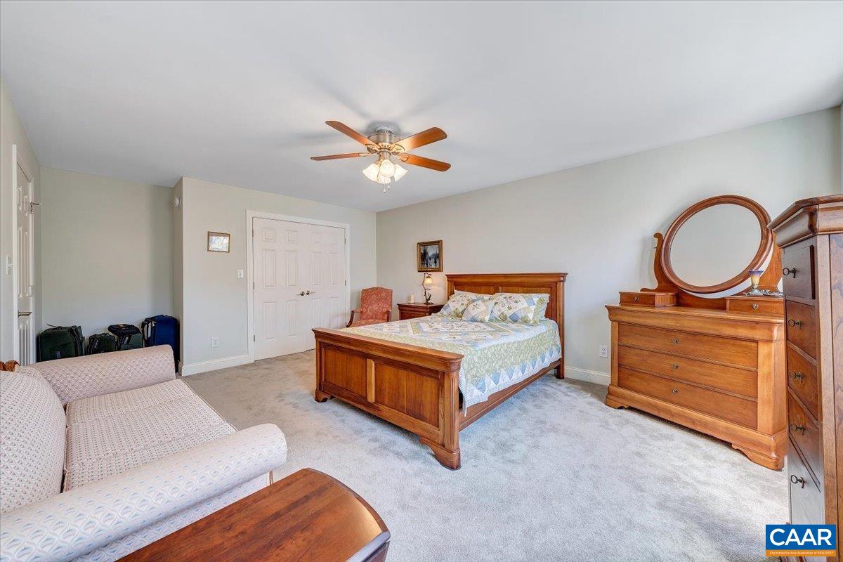 439 Gardner Farm Road Appomattox, VA 24522 - Photo 38 of 73 a bedroom with a bed a lamp and a dresser