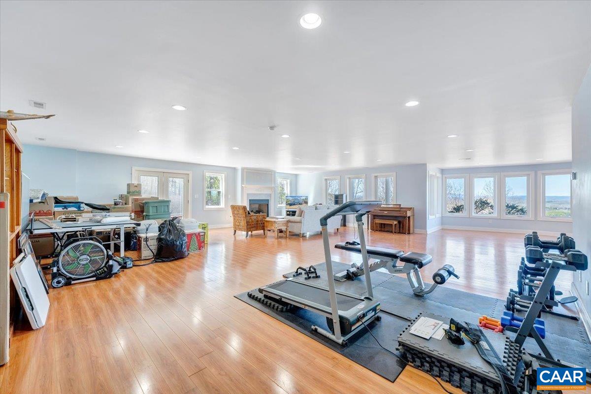 439 Gardner Farm Road Appomattox, VA 24522 - Photo 46 of 73 a living room with furniture a fireplace and a flat screen tv