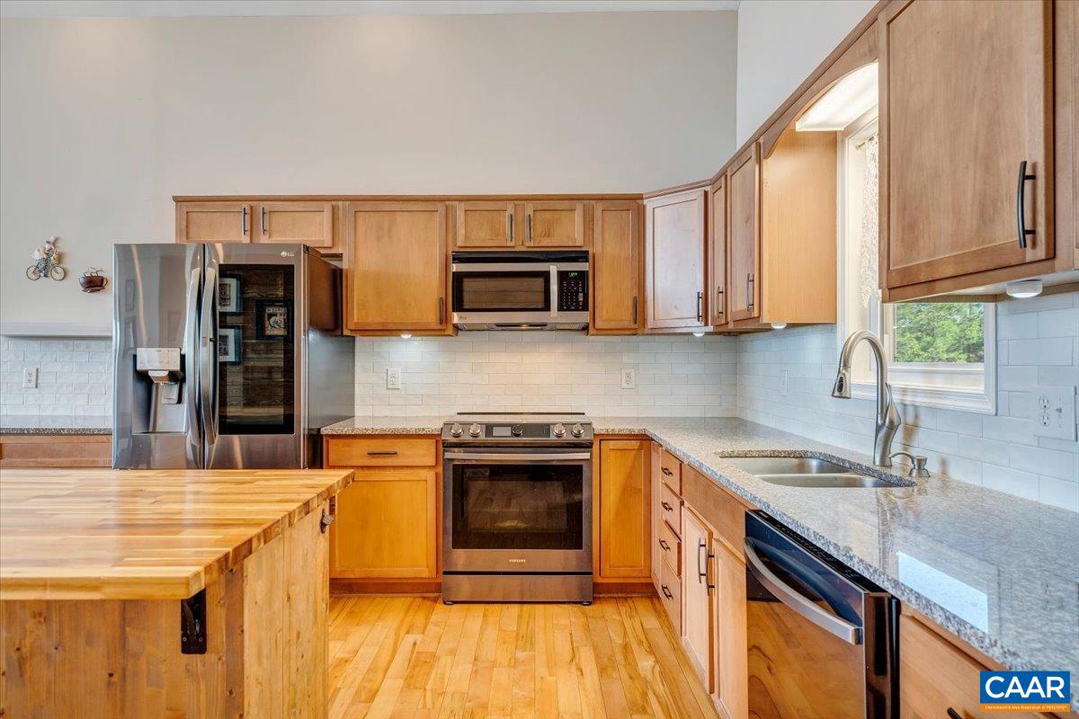 439 Gardner Farm Road Appomattox, VA 24522 - Photo 9 of 73 a kitchen with stainless steel appliances granite countertop a sink stove and refrigerator