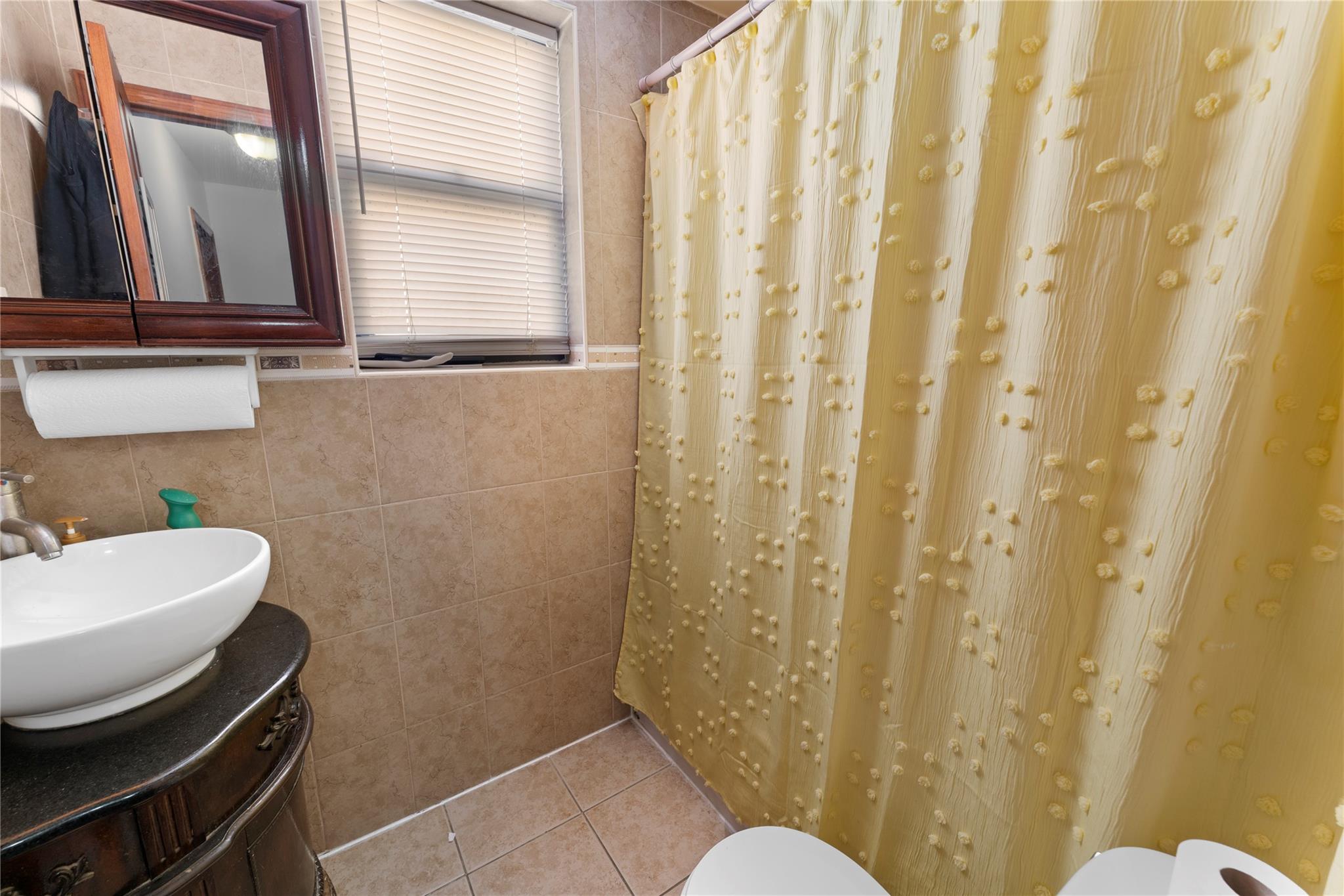 848 Morris Park Avenue Bronx, NY 10462 - Photo 11 of 22 a bathroom with a sink and a mirror