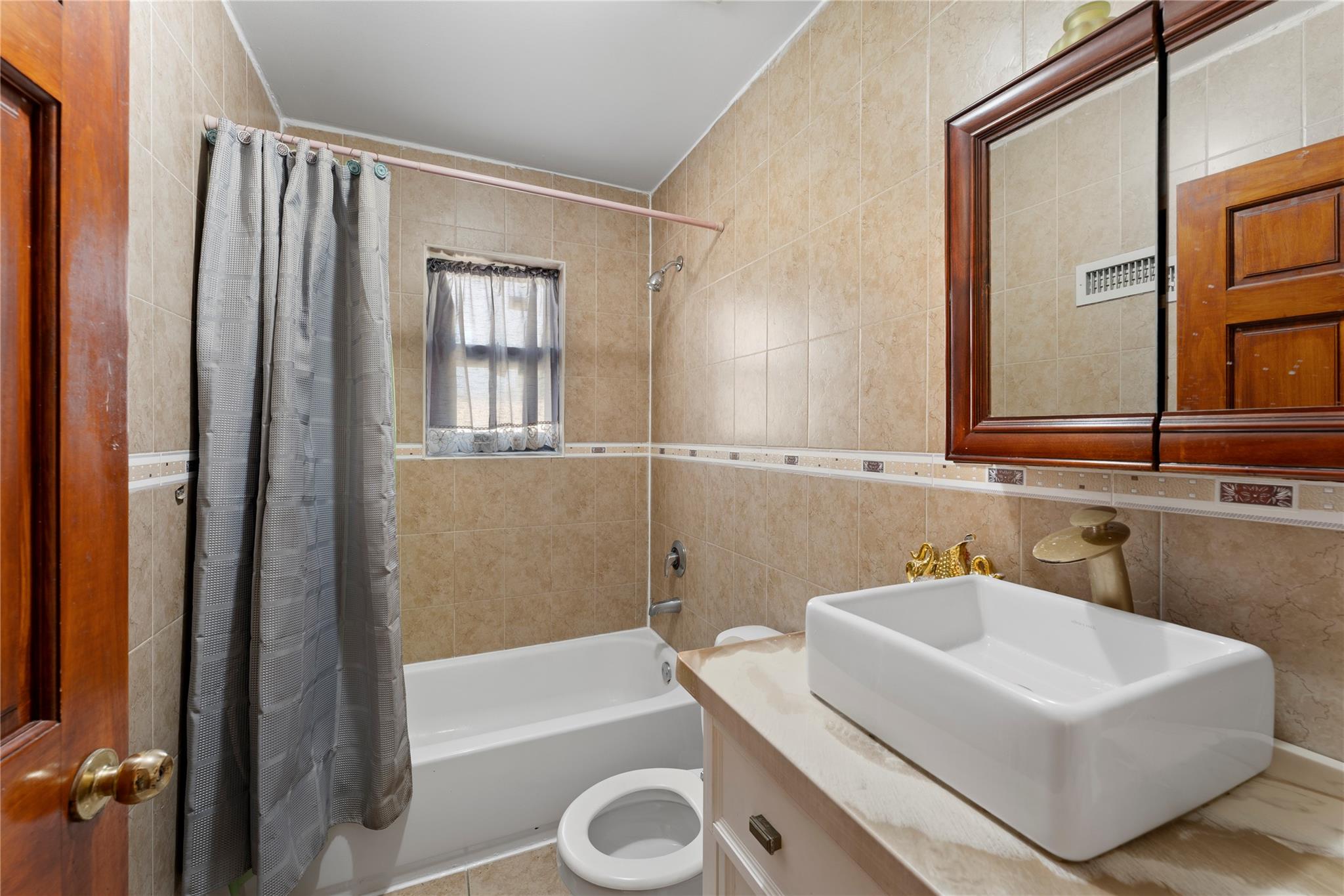 848 Morris Park Avenue Bronx, NY 10462 - Photo 13 of 22 a bathroom with a sink a toilet and shower