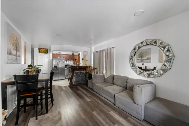 a living room with furniture potted plant and windows