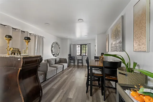 a living room with furniture a dining table and a bookshelf