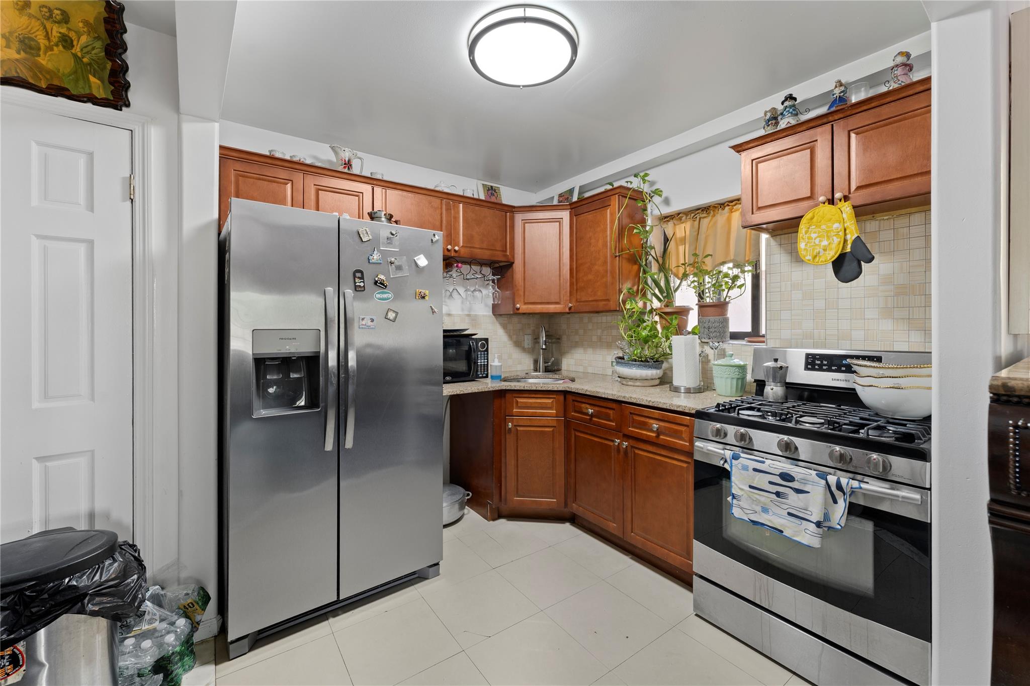 848 Morris Park Avenue Bronx, NY 10462 - Photo 5 of 22 a kitchen with stainless steel appliances granite countertop a refrigerator a sink and a stove