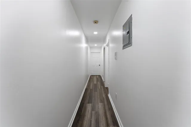 a kitchen with a table chairs refrigerator and cabinets