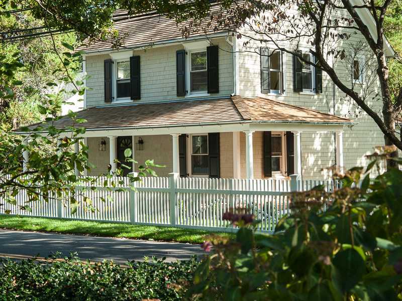 226 Riverside Avenue Riverside, CT 06878 - Photo 1 of 24 a front view of a house with a garden