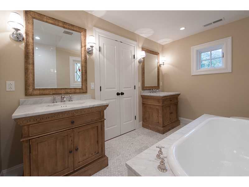 226 Riverside Avenue Riverside, CT 06878 - Photo 13 of 24 a bathroom with a sink a mirror and a shower