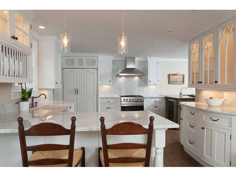226 Riverside Avenue Riverside, CT 06878 - Photo 6 of 24 a kitchen with stainless steel appliances kitchen island granite countertop a table chairs sink and cabinets