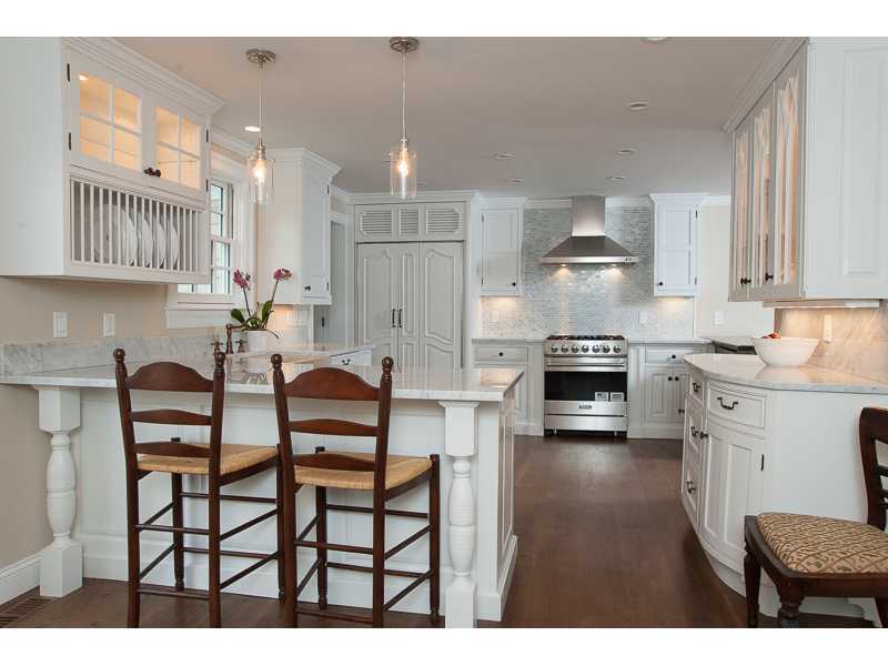 226 Riverside Avenue Riverside, CT 06878 - Photo 7 of 24 a kitchen with stainless steel appliances kitchen island granite countertop a table chairs sink and cabinets