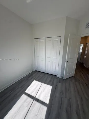 a view of a room with wooden floor and staircase