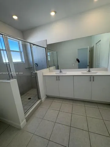 a bathroom with a double vanity sink and mirror
