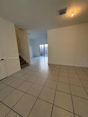 a view of a livingroom with an empty space and a window